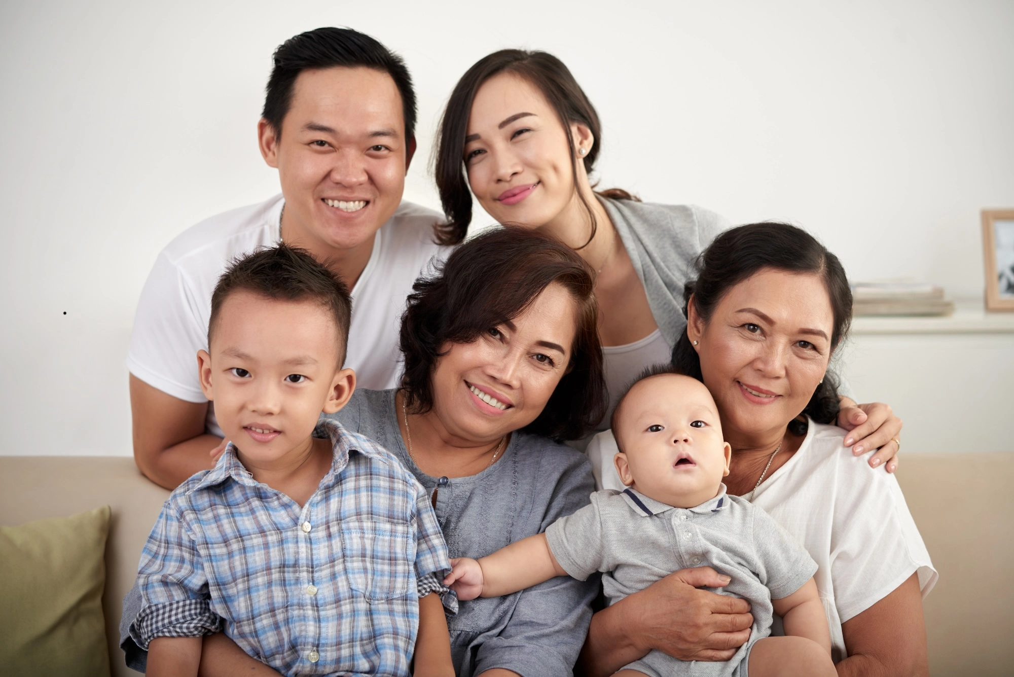 Happy family posing together with Indonesian Maid Myanmar Maid in Singapore Agency