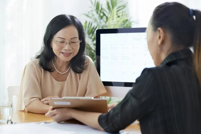 foreign domestic worker talking to maid agency agent in singapore for employment contract